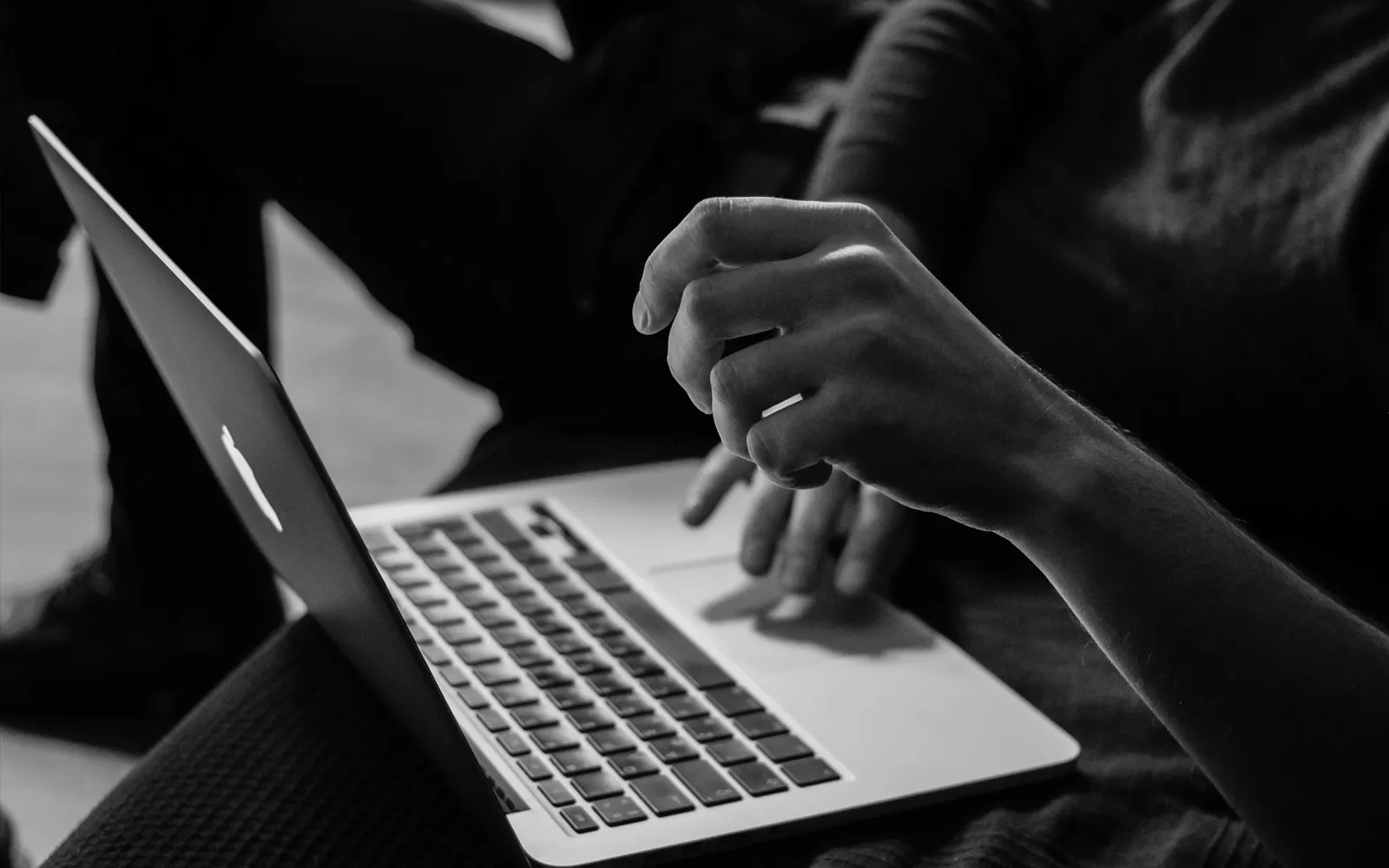Officer reviewing paper documents alongside a laptop screen