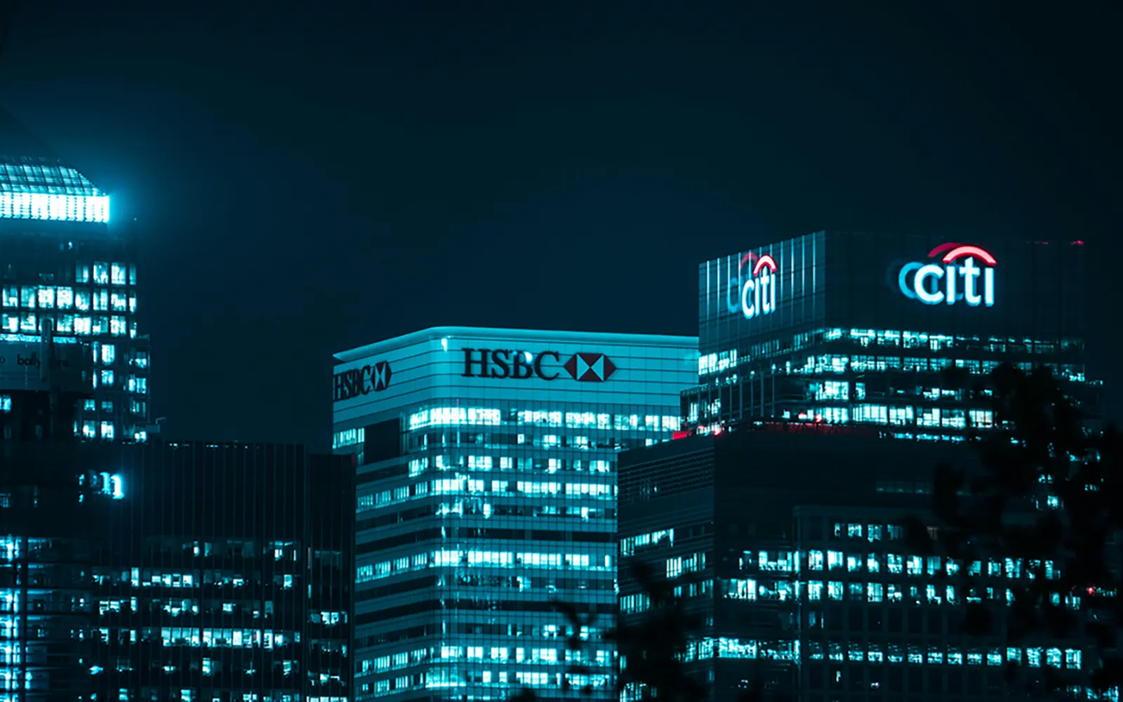 Employee looking at monitors in a financial institution office