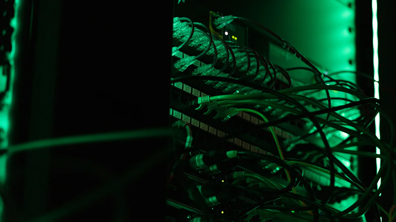 Network equipment and cables under green lighting