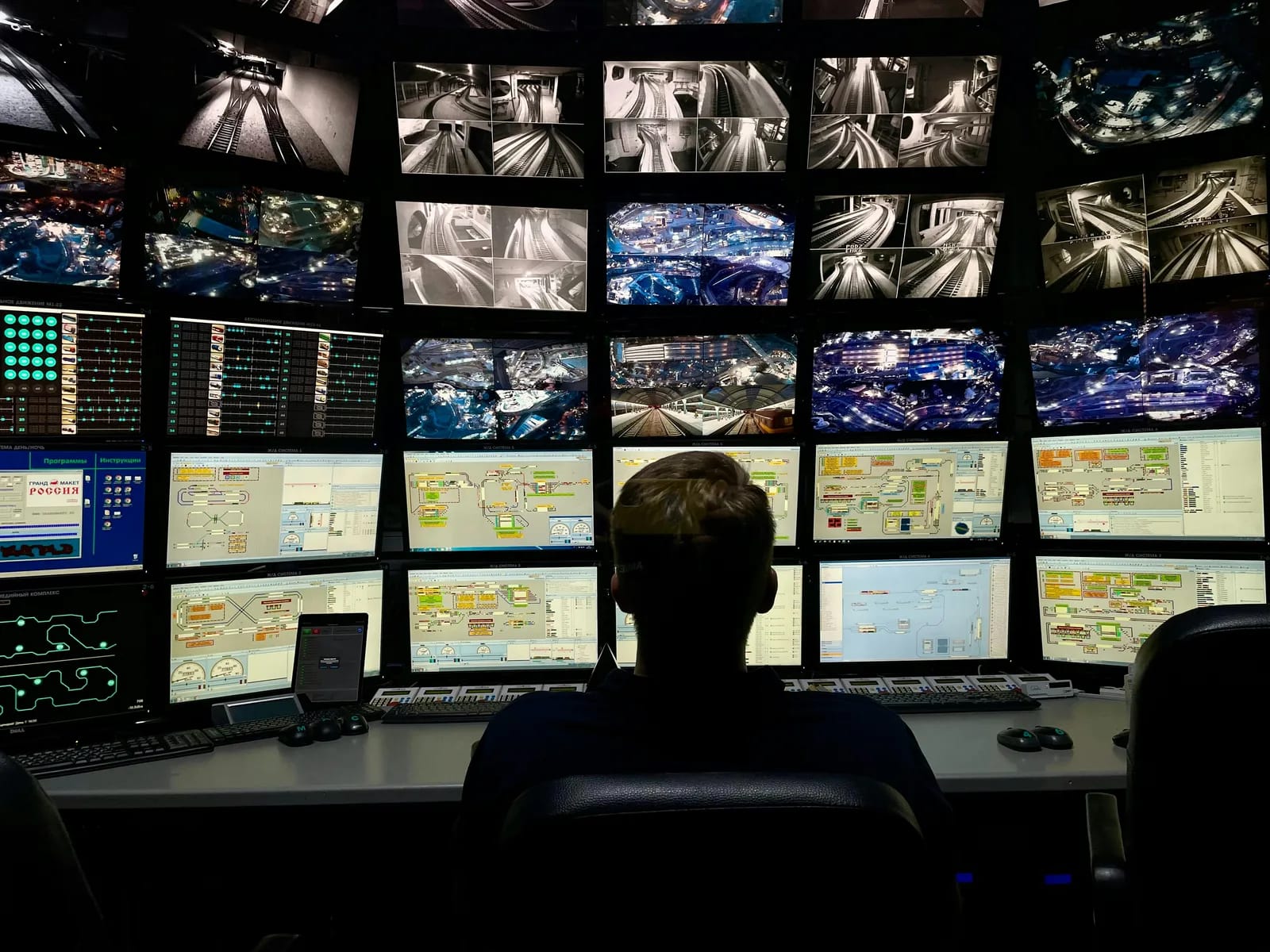 A security operations center monitoring systems in real time across many screens