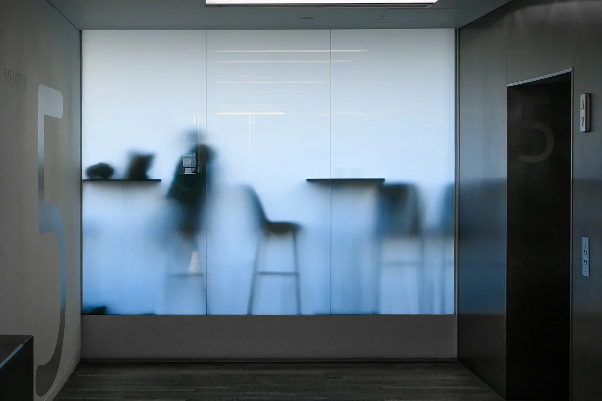 Modern office interior with connected hallways and frosted glass walls